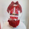 Bolha transparente personalizada com Body Noel dentro, acompanhada de uma manta de tricô e apresentada em uma caixa cartonada.