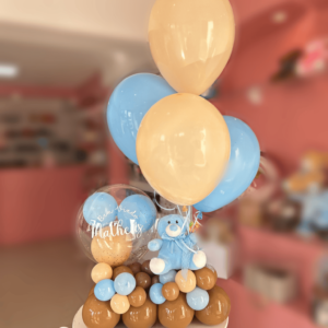 Arranjo de boas-vindas com ursinho de pelúcia azul e balão bubble com confetes e balões internos, Maria Festeira.